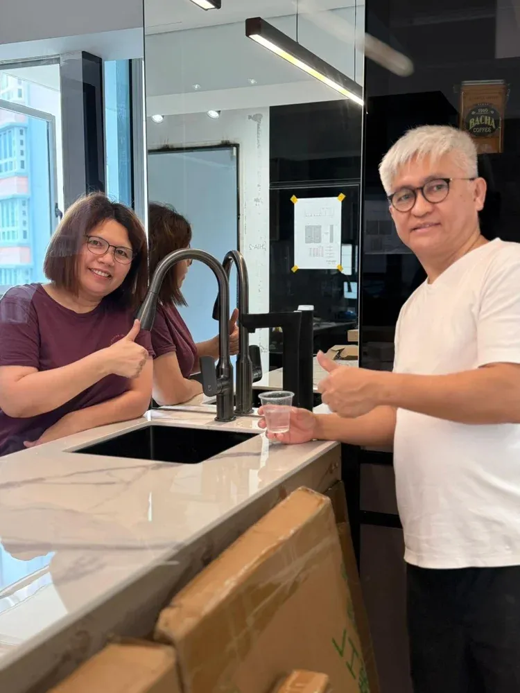 AquaLuxe customers filling a cup from the EliteTap tap in their kitchen